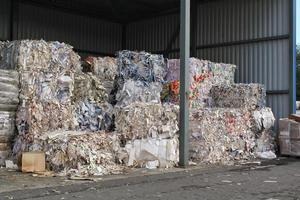 Wastepaper compact texture pile for recycling on sorting plant. Technology of reuse materials. Stack of shredded paper. Save the planet ecology concept. Industry of reduced pollution factory. Close-up photo