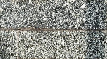 texture of old granite tiles on the wall photo