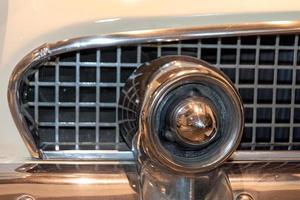 radiator grille and headlight of retro car photo