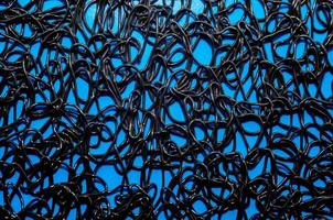 texture pattern of dark brown rubber on a blue background photo