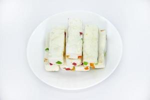 Pieces of juicy marshmallow on a white plate. Sweet oriental snack. Sweets for tea. photo