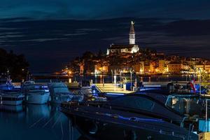 Picture of the illuminated historic part of Rovinj at night photo