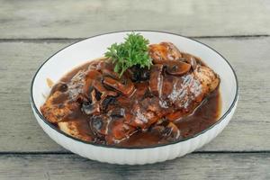 Pan Seared Chicken Cajun cuisine with grey wooden background photo