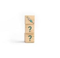 Questions when the vaccine against in covid in wooden cube blocks. photo