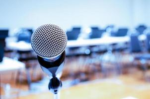 Microphone and Notebook on abstract blurred of speech in seminar room photo