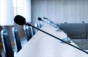 Close up microphone on brown table in meeting room photo