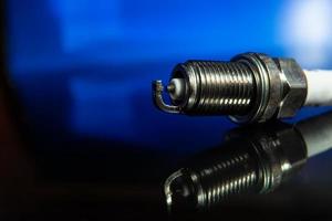 macrophoto of spark plugs on a blue background photo