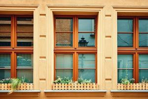 Vintage building facade with windows and flowers on windowsill photo