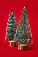 Merry Christmas and Happy New Year composition with christmas tree on red background photo