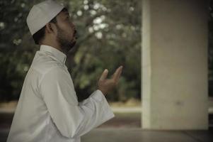 Asian islam man prayer,Young Muslim praying,Ramadan festival concept photo