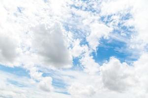 Nature background from white clouds in sunny day. Beautiful white fluffy clouds in blue sky. photo
