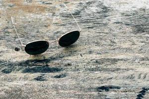 Sunglasses on wooden table summer concept background photo