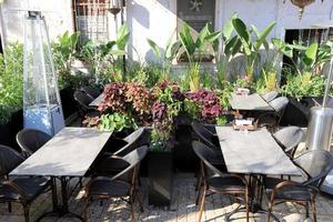 Chair and table in a cafe in a city park near the sea. photo