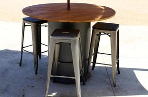 Chair and table in a cafe in a city park near the sea. photo