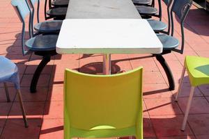 silla y mesa en un café en un parque de la ciudad cerca del mar. foto