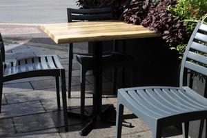 Chair and table in a cafe in a city park near the sea. photo