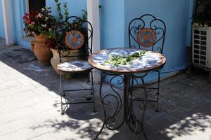 Chair and table in a cafe in a city park near the sea. photo