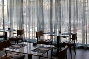 Chair and table in a cafe in a city park near the sea. photo