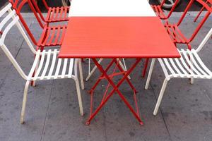 Chair and table in a cafe in a city park near the sea. photo