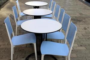 Chair and table in a cafe in a city park near the sea. photo