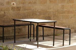 Chair and table in a cafe in a city park near the sea. photo