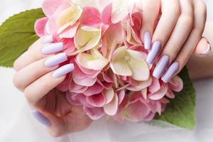 Girl's hands with a soft purple manicure. photo