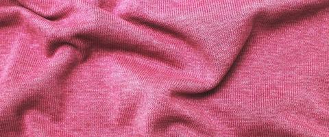 burgundy viva magenta wrinkled plush fabric background texture, soft material pattern. banner photo