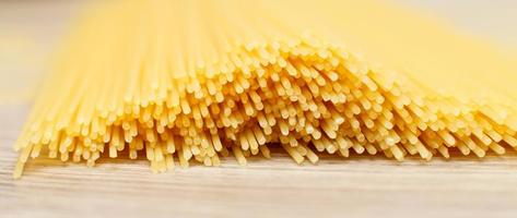 spaghetti yellow background close. raw pasta macro photo