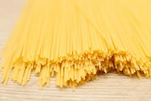 spaghetti yellow background close. raw pasta macro photo