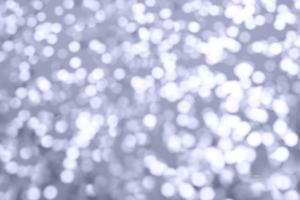 multicolor sparkles on a purple background. Festive backdrop for your projects. photo