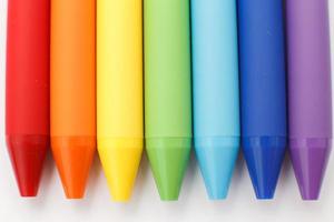 Multicolored in rainbow colors gel pens isolated on a white background, close-up. Copy space photo