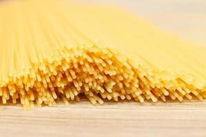 spaghetti yellow background close. raw pasta macro photo