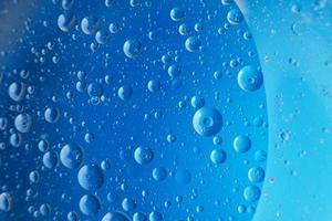 abstract light blue background with oil circles . bubbles of water close up . photo