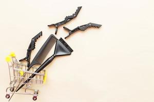 various hairdressing tools with shopping cart on a beige background. beauty salon concept photo