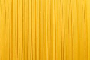 spaghetti yellow background close. raw pasta macro photo