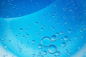 abstract light blue background with oil circles . bubbles of water close up . photo
