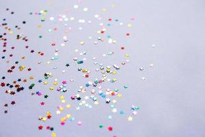 multicolor sparkles on a purple background. Festive backdrop for your projects. photo