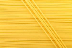 spaghetti yellow background close. raw pasta macro photo