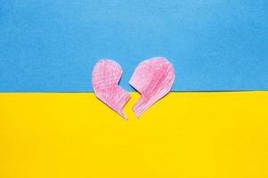 broken red heart on the ukrainian flag background photo