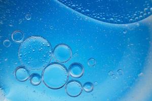 abstract light blue background with oil circles . bubbles of water close up . photo