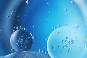 abstract light blue background with oil circles . bubbles of water close up . photo