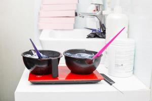 a bowl with hair dye in beauty salon close. photo