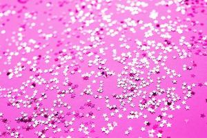 pink sparkles on a purple background. Festive backdrop for your projects.