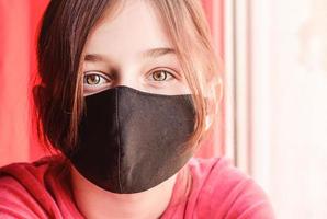 A girl in a protective mask. Illness and protection. Viruses and bacteria. photo