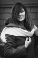 Close up smiling lady in coat with scarf monochrome portrait picture photo