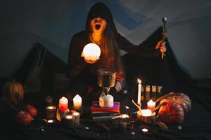 Close up woman casting spell with glowing ball and spoon portrait picture photo