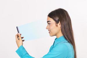 Biometric identification. Young beautiful woman scanning face with facial recognition system on smartphone. photo