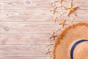 summer holiday beach background with accessories on wooden table, top view with copy space. vacation concept photo