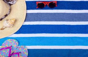 Straw Beach Woman's Hat Sun Glasses Top View Seashell Flip flops with space for text. photo