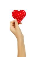 Hand holding a red heart isolated on white background photo